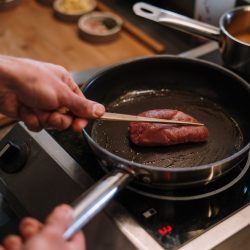 person-cooking-meat-on-black-pan-4253293 (Medium)